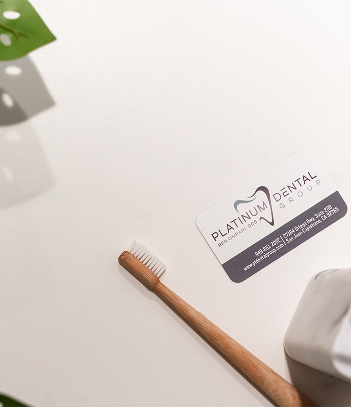 Toothbrush and Platinum Dental Group of San Juan Capistrano business card