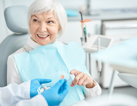 A woman discussing All-on-4 with her dentist