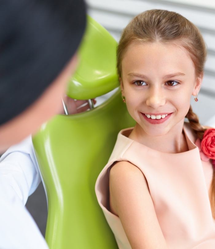 Young child smiling at dentist during children's dentistry visit