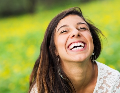 Woman sharing flawless smile after makeover