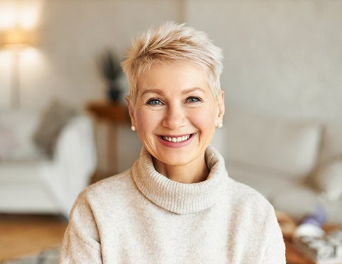 a woman smiling with dentures in San Juan Capistrano