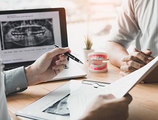 Emergency dentist reviewing treatment plan with patient