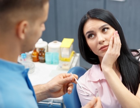 Woman visiting dentist for emergency dentistry