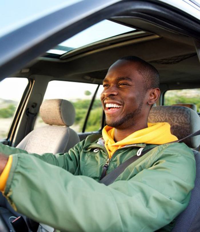 Man smiles while driving
