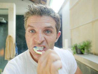 Man brushing dental implants in San Juan Capistrano