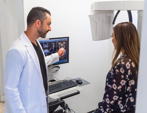 Dentist and dental patient discussing the cost of dental implants