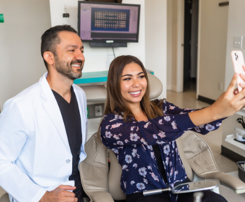 Patient smiling for a selfie with Dr. Omrani