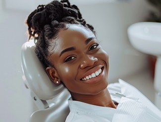 Woman smiling while sitting in treatment chair