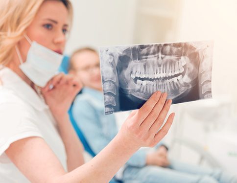dentist looking at patient X-ray