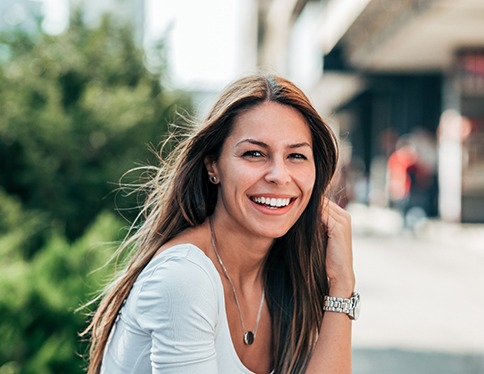 patient smiling while sitting outside 