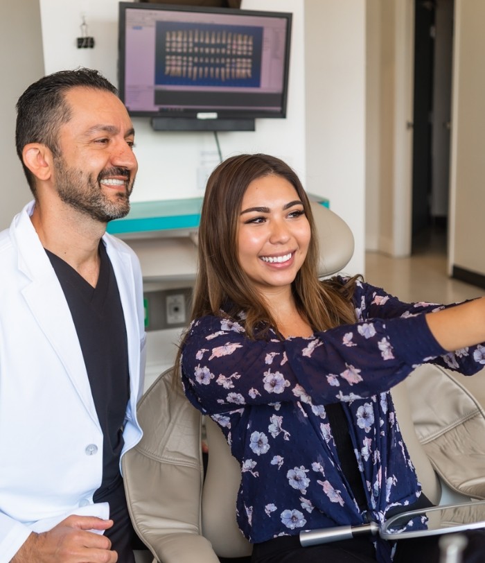 Dentist and patient taking a picture together