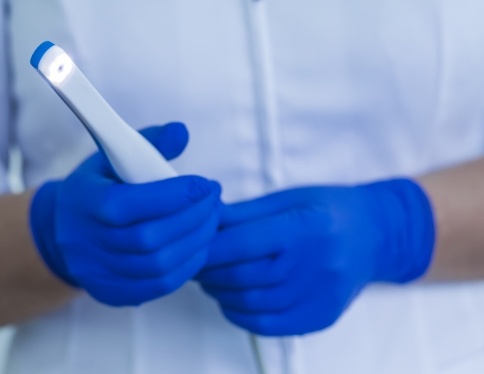 Dentist holding an intraoral camera