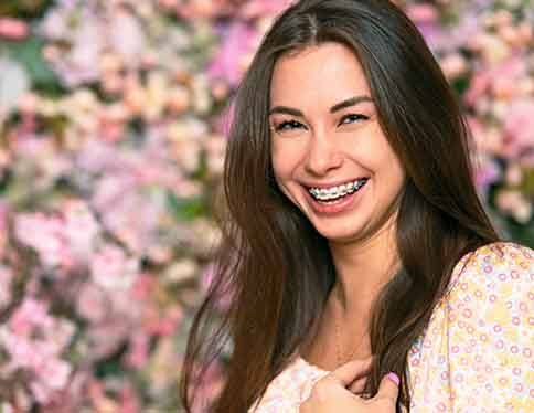 Woman in garden smiling with braces