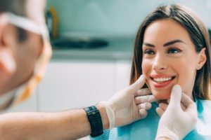 a woman smiling at her dentist after receiving cosmetic dentistry