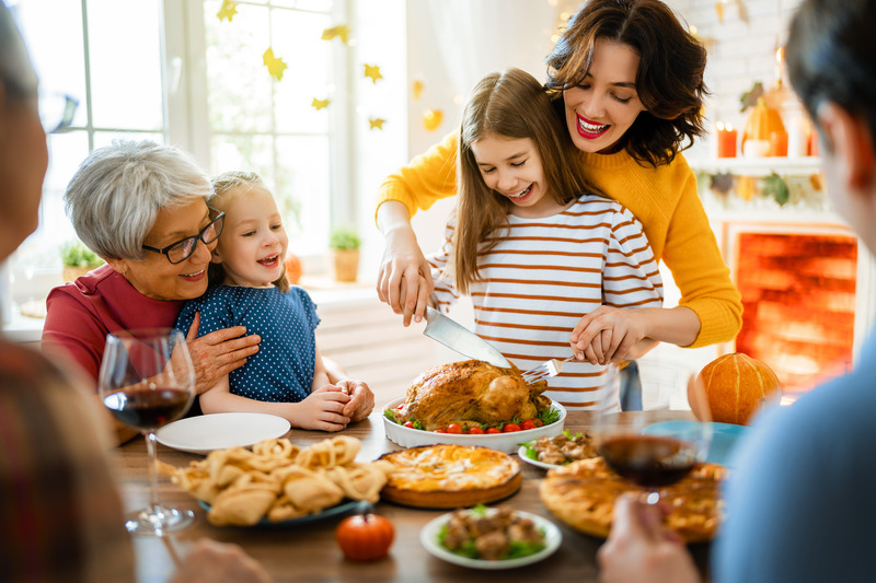 Patient with good oral health smiling with family at Thanksgiving
