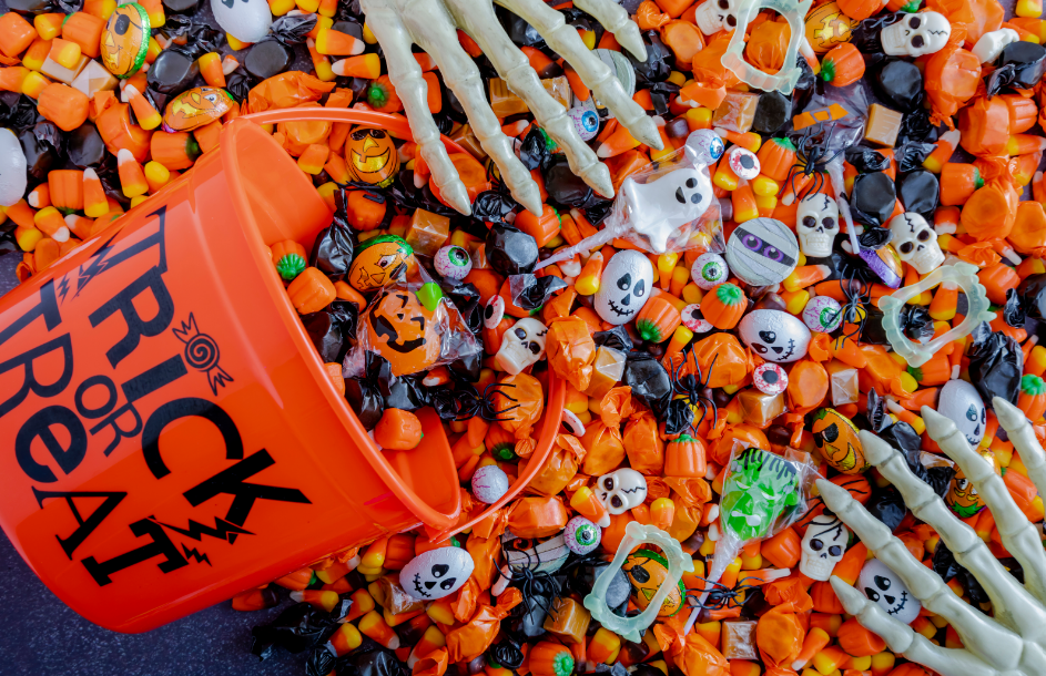 Halloween candy spilling from orange bucket